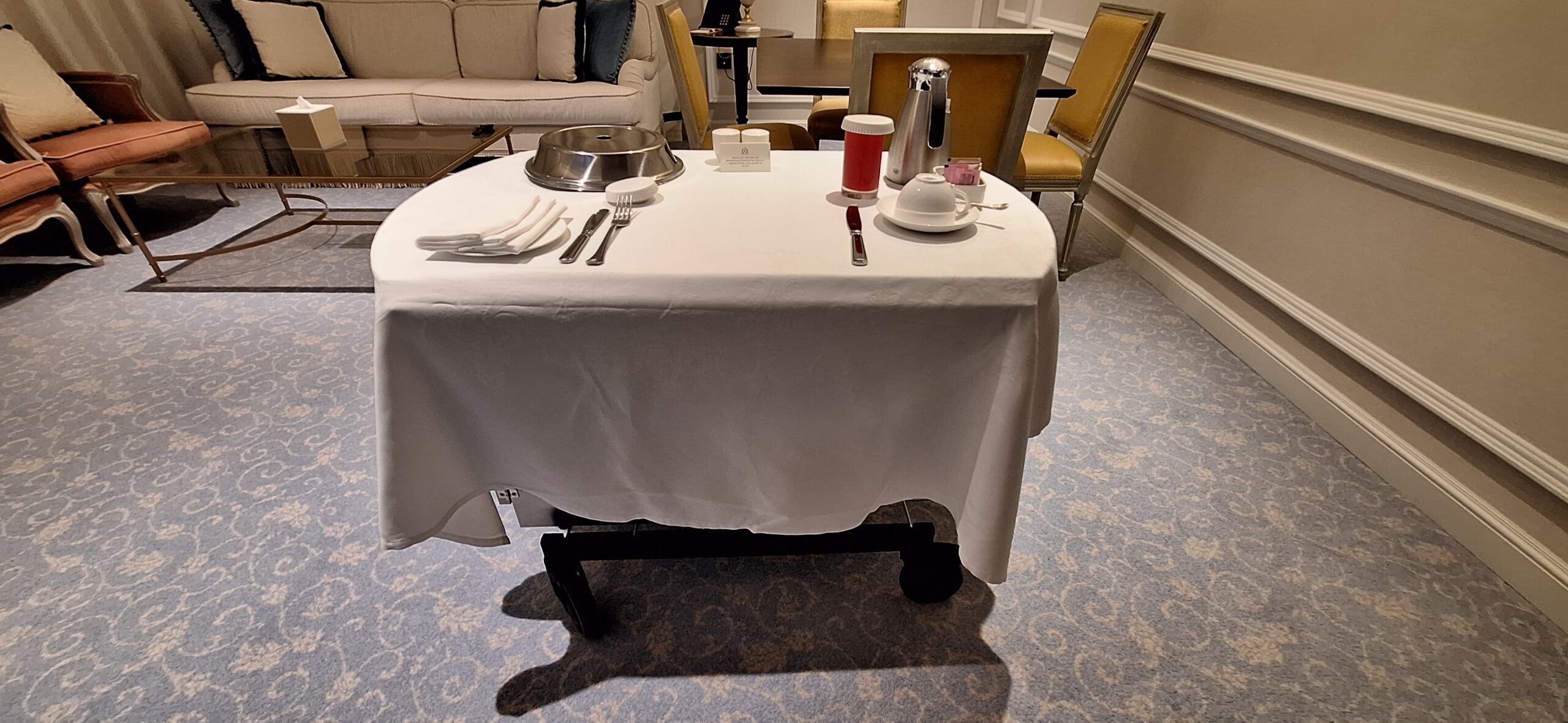 a table with a white tablecloth and silverware on it