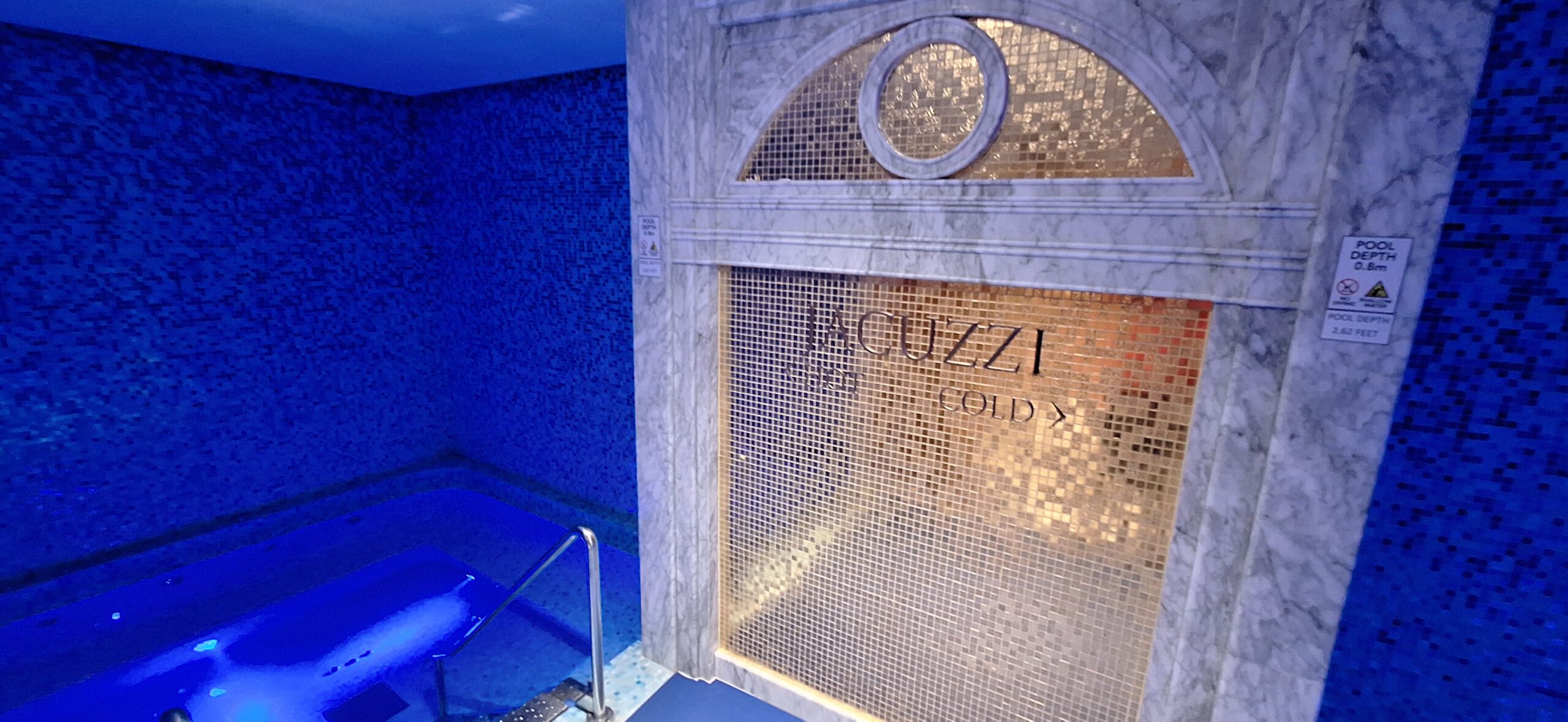 a tiled wall with a sign in it