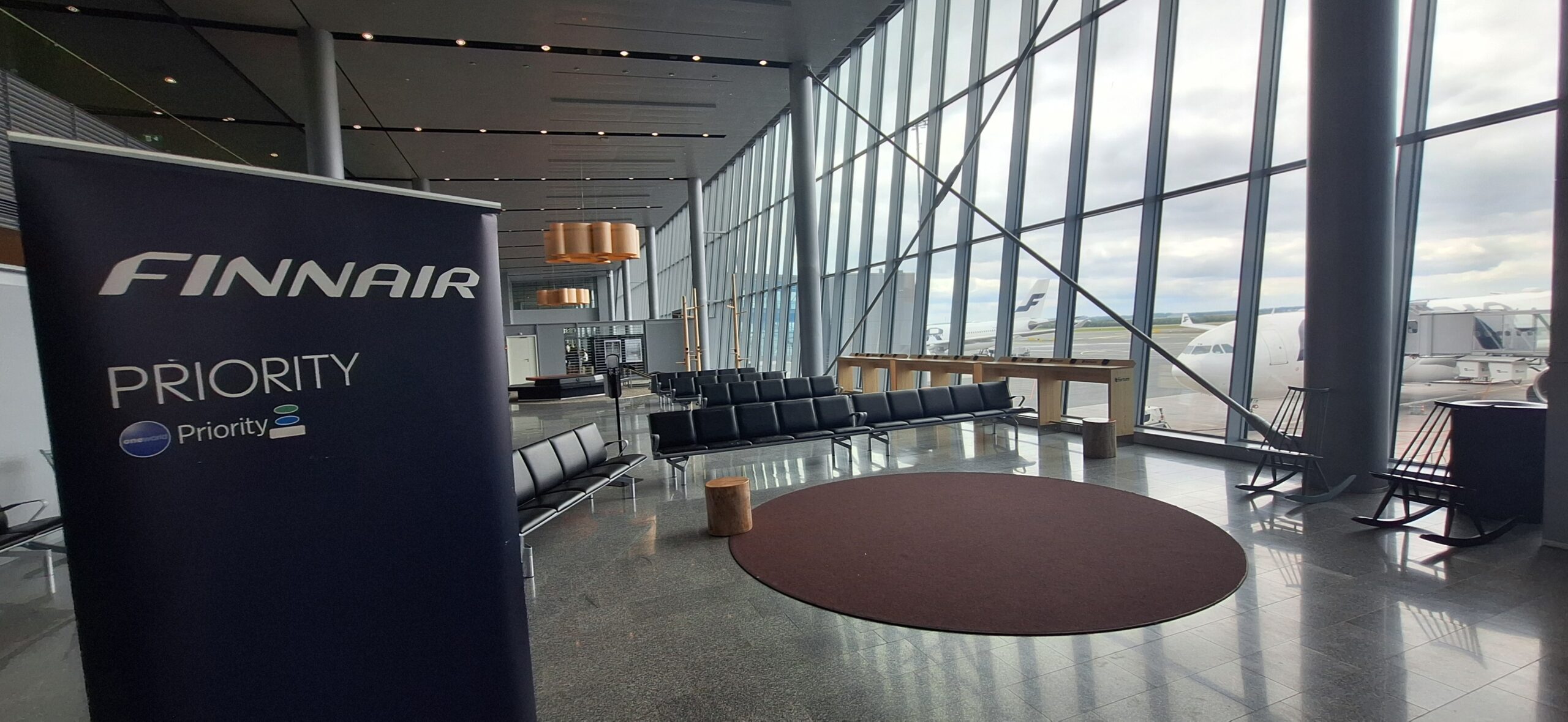 a large glass window with a large area with chairs and a table