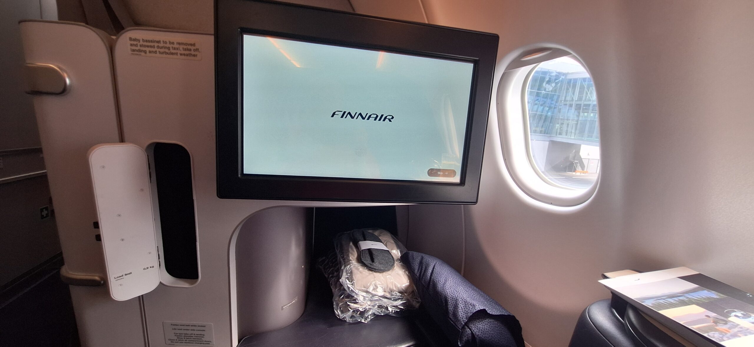 a screen on a seat in an airplane