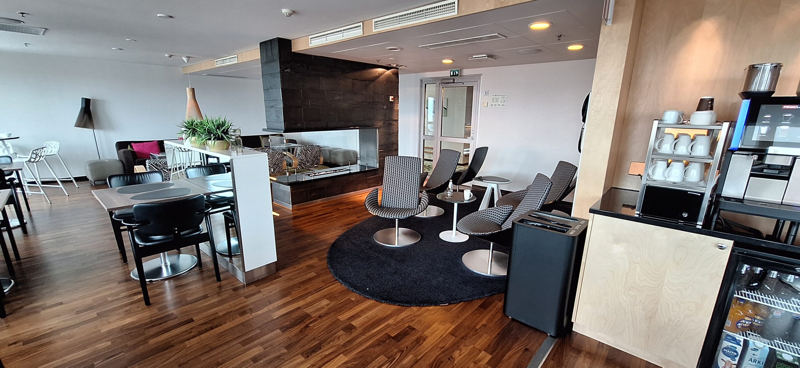 a room with chairs and a fireplace