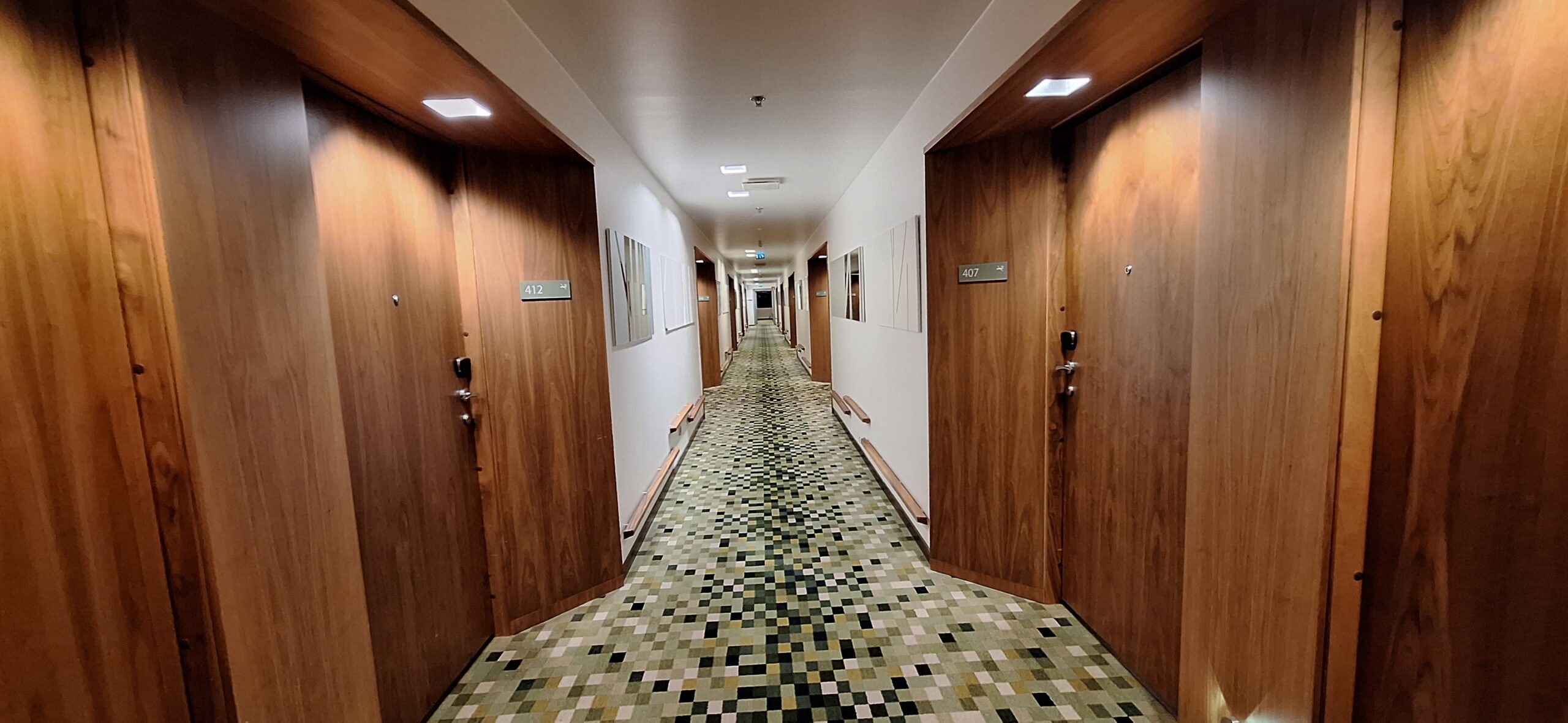 a long hallway with wooden doors