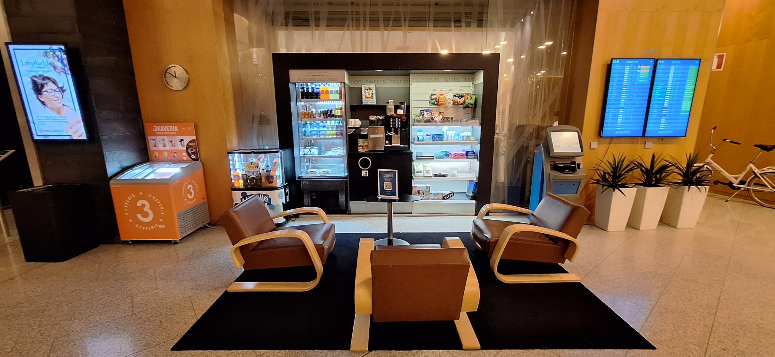 a room with chairs and a beverage machine