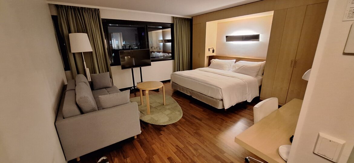 a room with a bed and a television