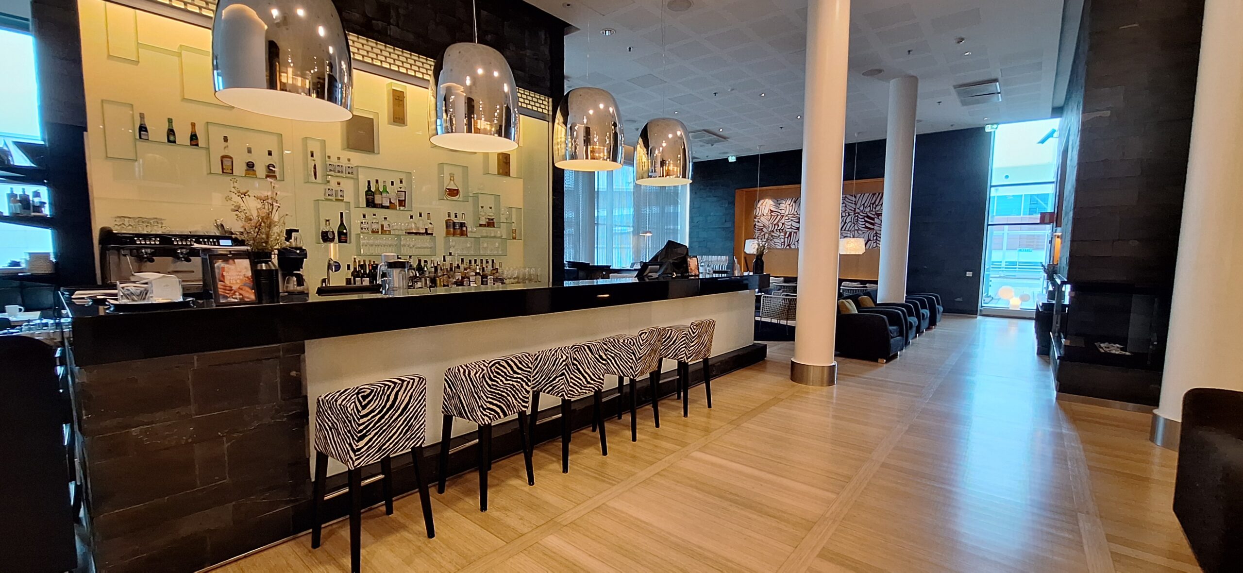 a bar with zebra print chairs and lights