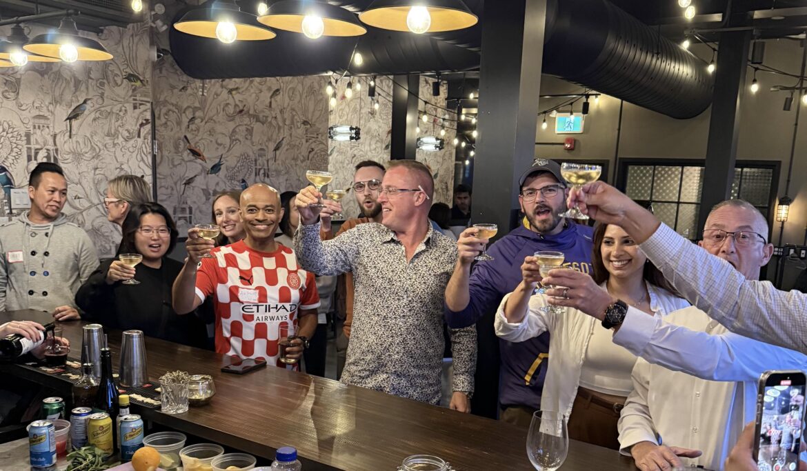 a group of people holding glasses of wine