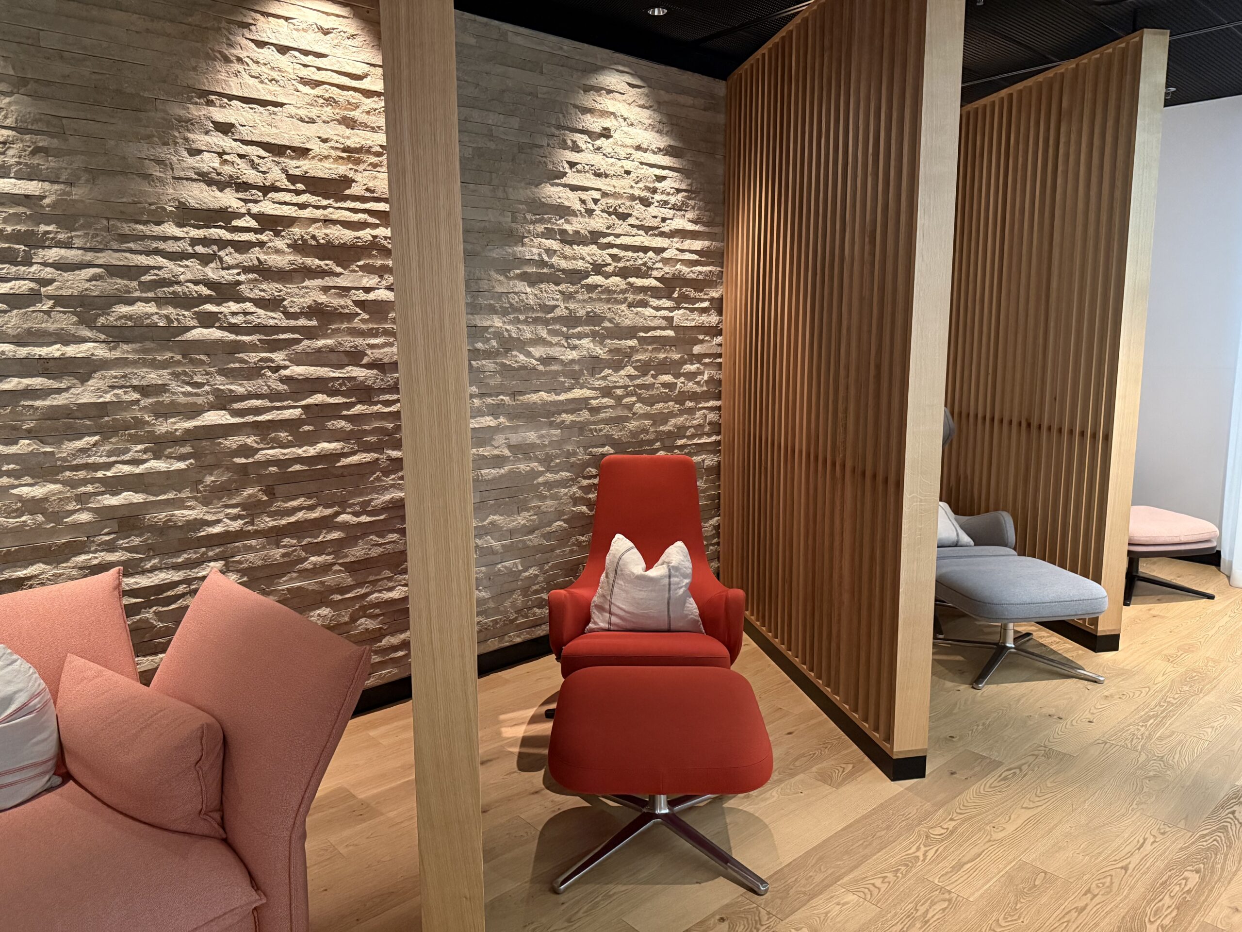 a room with a red chair and a grey chair