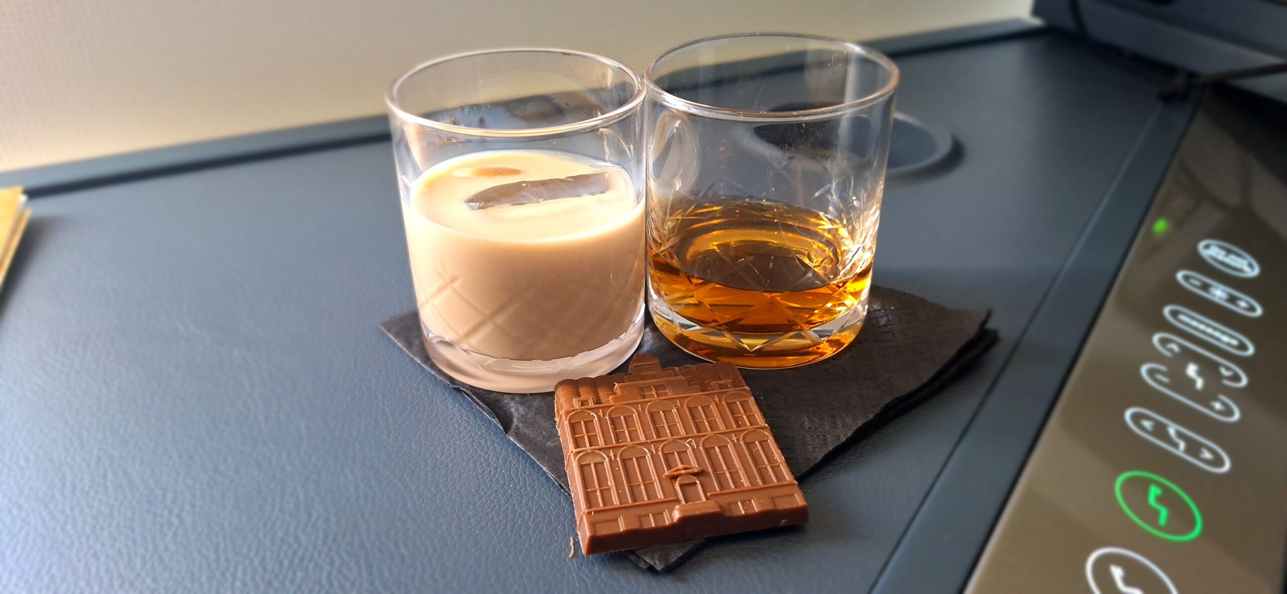 two glasses of alcohol and a chocolate bar