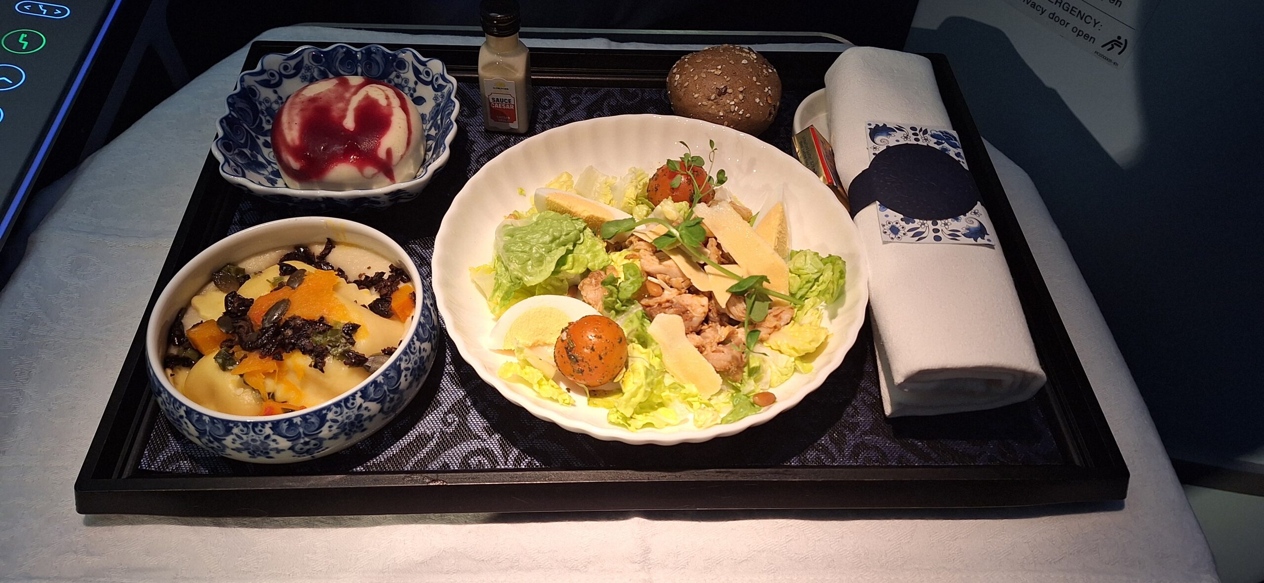a plate of salad and other food on a tray