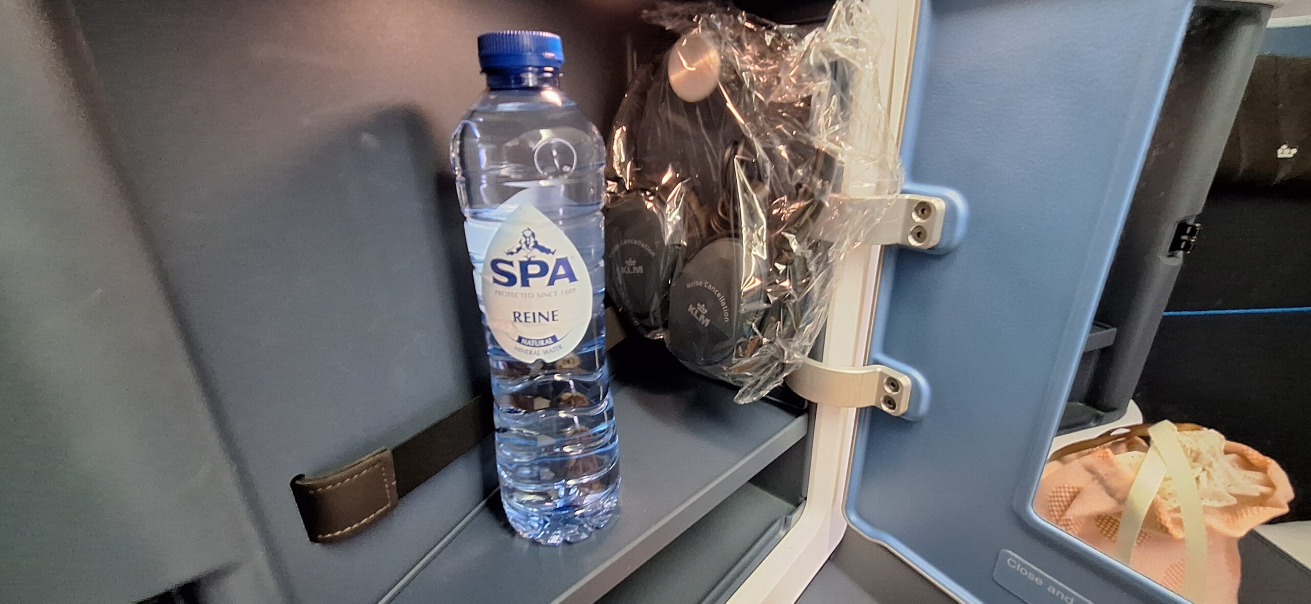 a bottle of water and headphones in a plastic bag