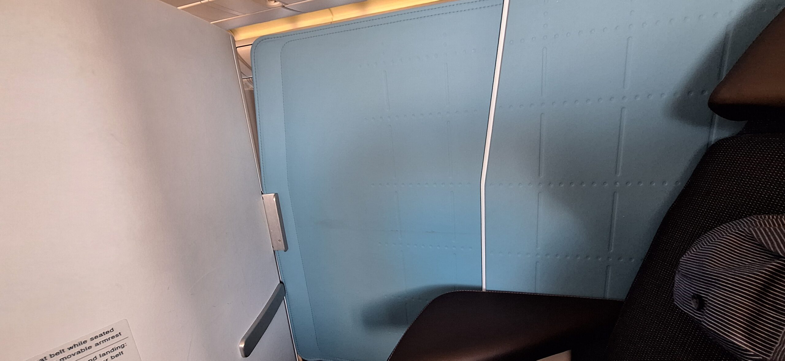 a blue door with a black chair