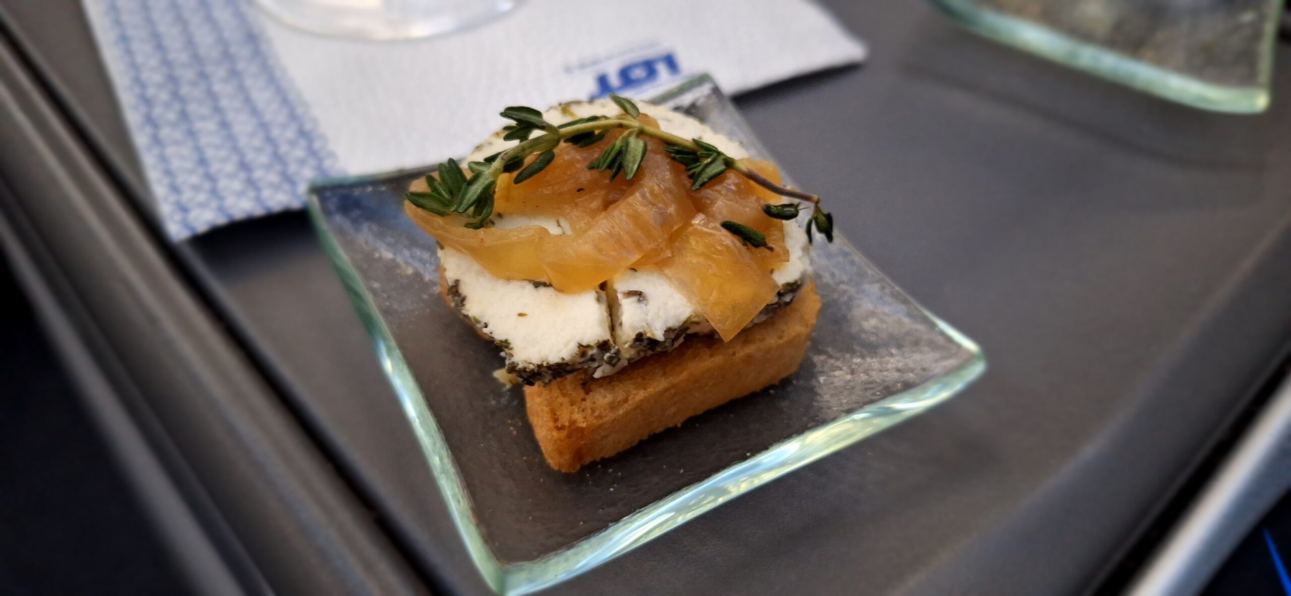 a small square plate with food on it