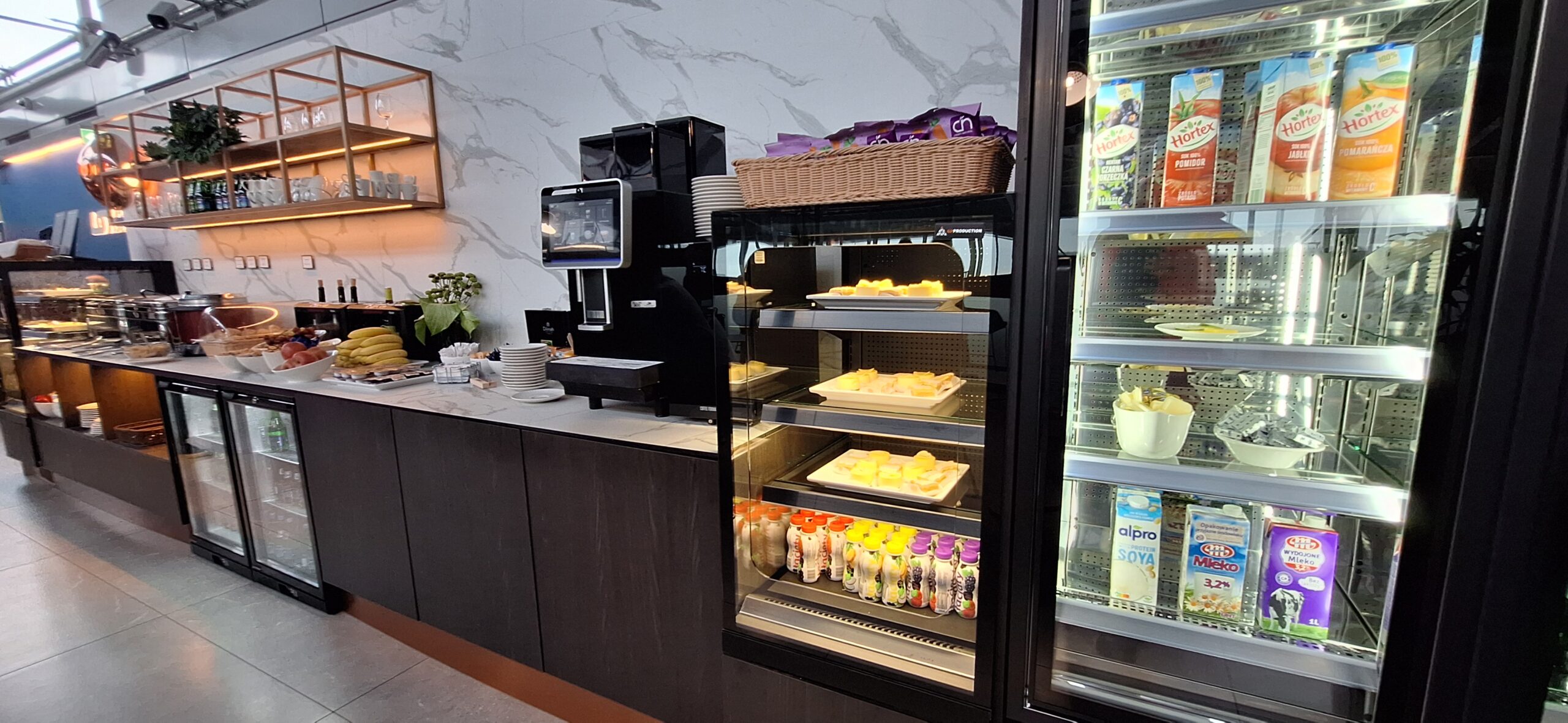 LOT Business Lounge review a display case with food on shelves