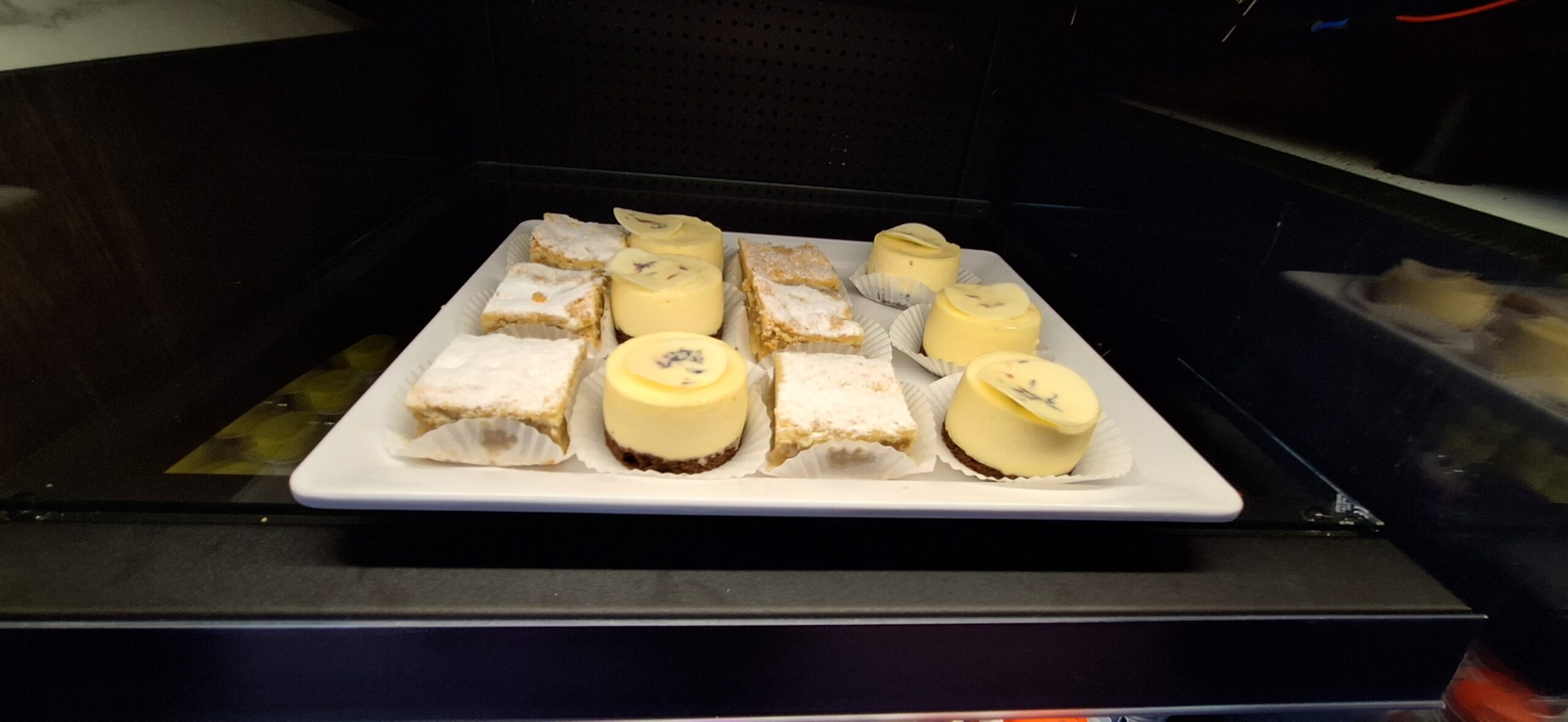 LOT Business Lounge review a plate of desserts on a black surface