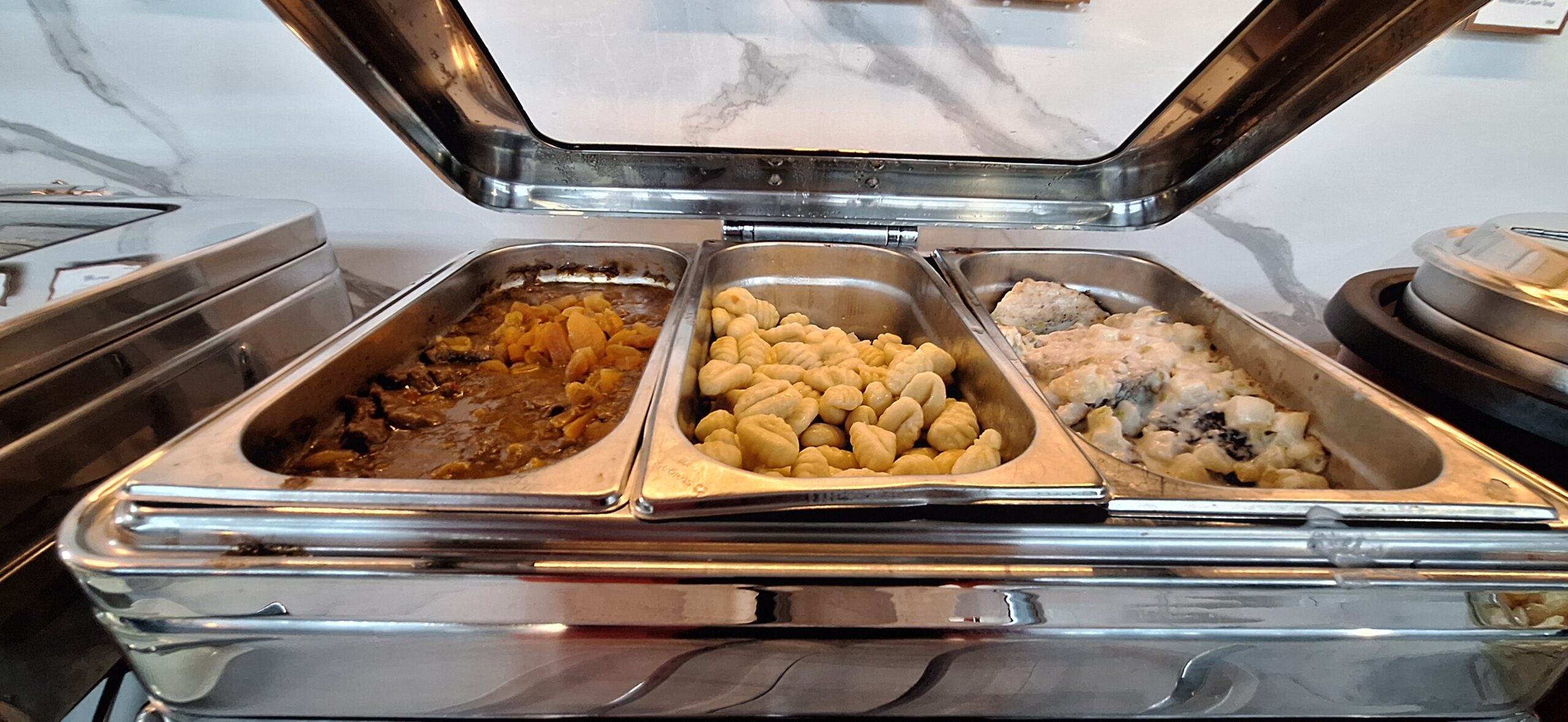 LOT Business Lounge review a trays of food in a buffet