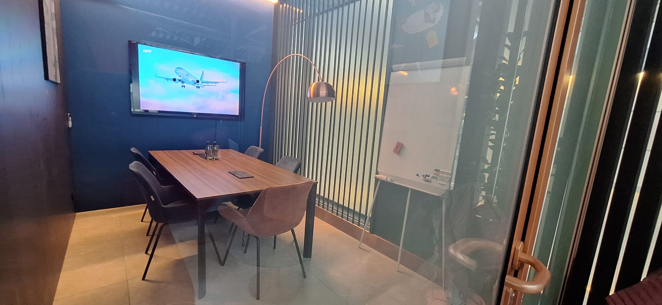 LOT Business Lounge review a room with a table and chairs and a whiteboard