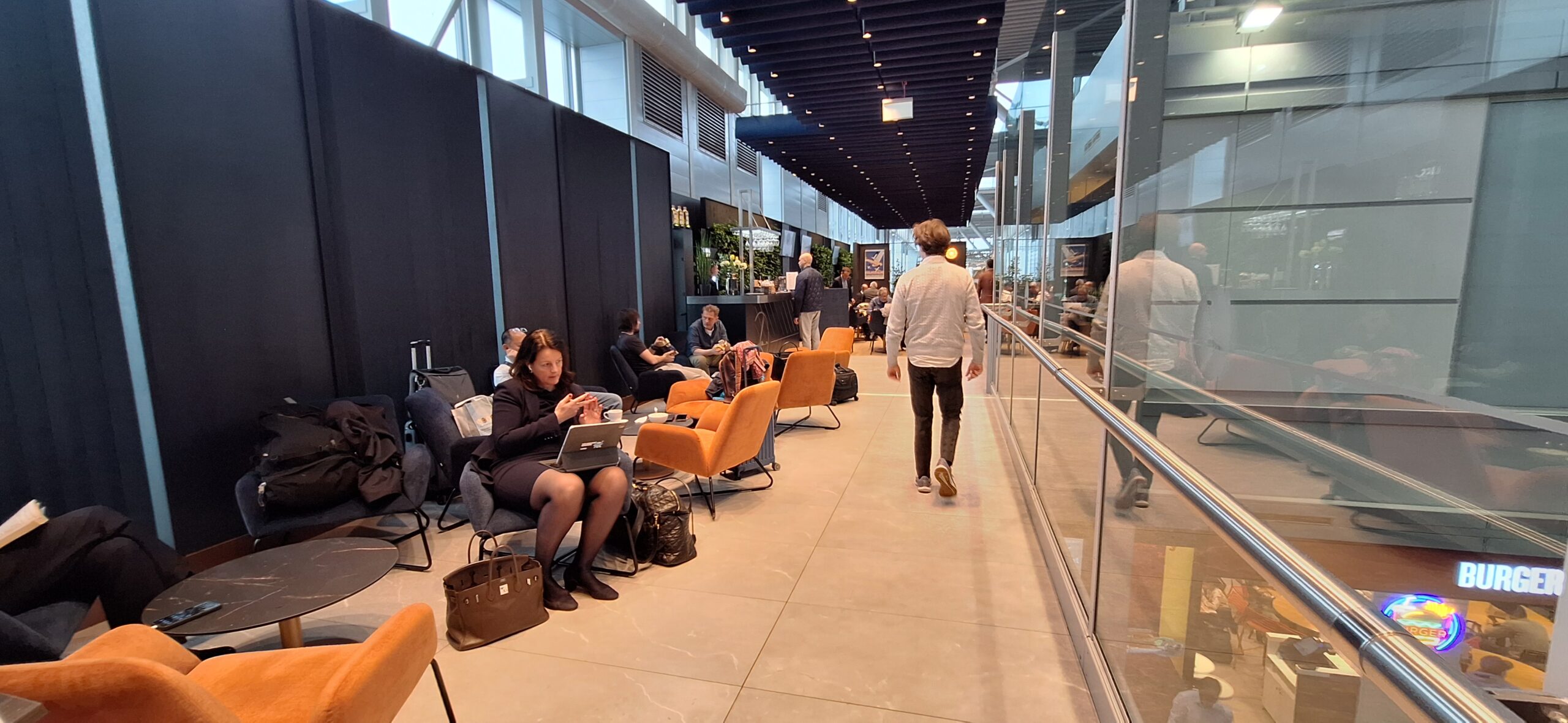 LOT Business Lounge review a group of people sitting in chairs in a lobby
