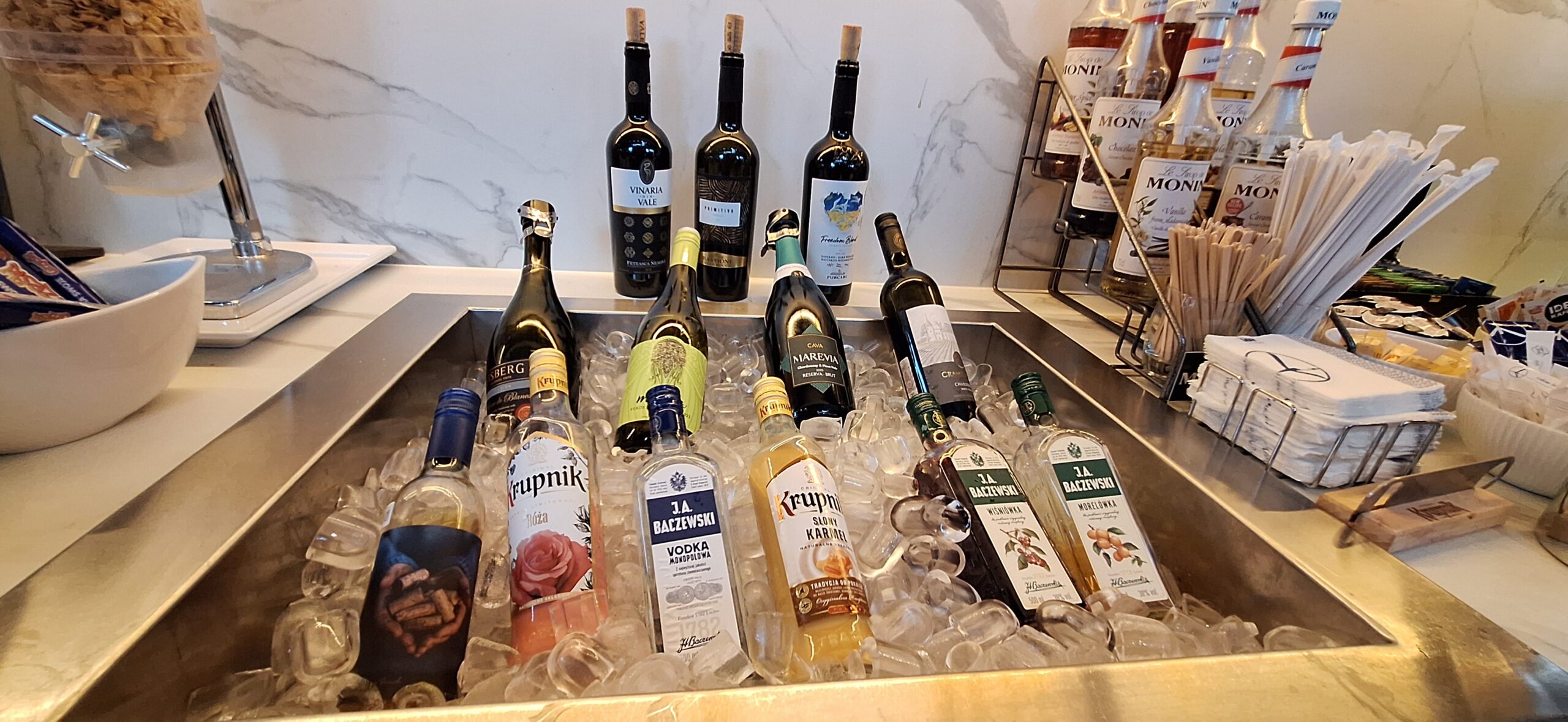 LOT Business Lounge review a group of bottles of alcohol in ice