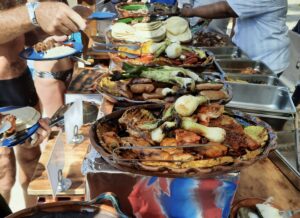 Review Viva Azteca Resort Mexico a group of people standing around a buffet table full of food