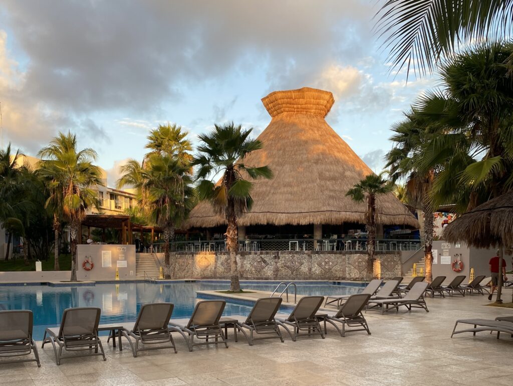 a pool with lounge chairs and palm trees