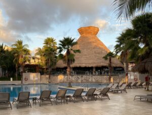 Review Viva Azteca Resort Mexico a pool with lounge chairs and palm trees