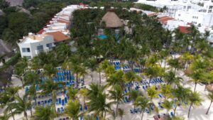 Review Viva Azteca Resort Mexico a group of palm trees and a resort