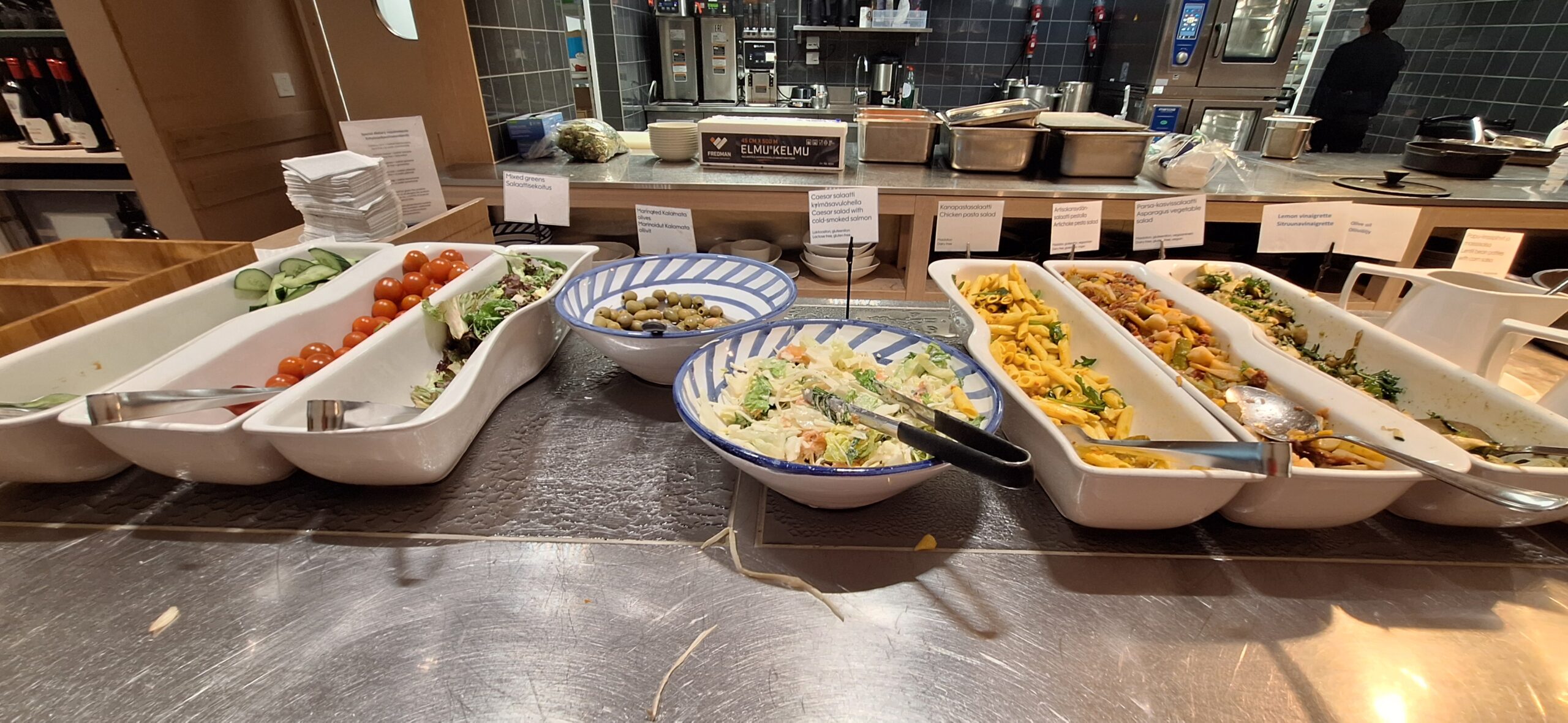 Finnair Business Class Lounge a buffet table with different types of food