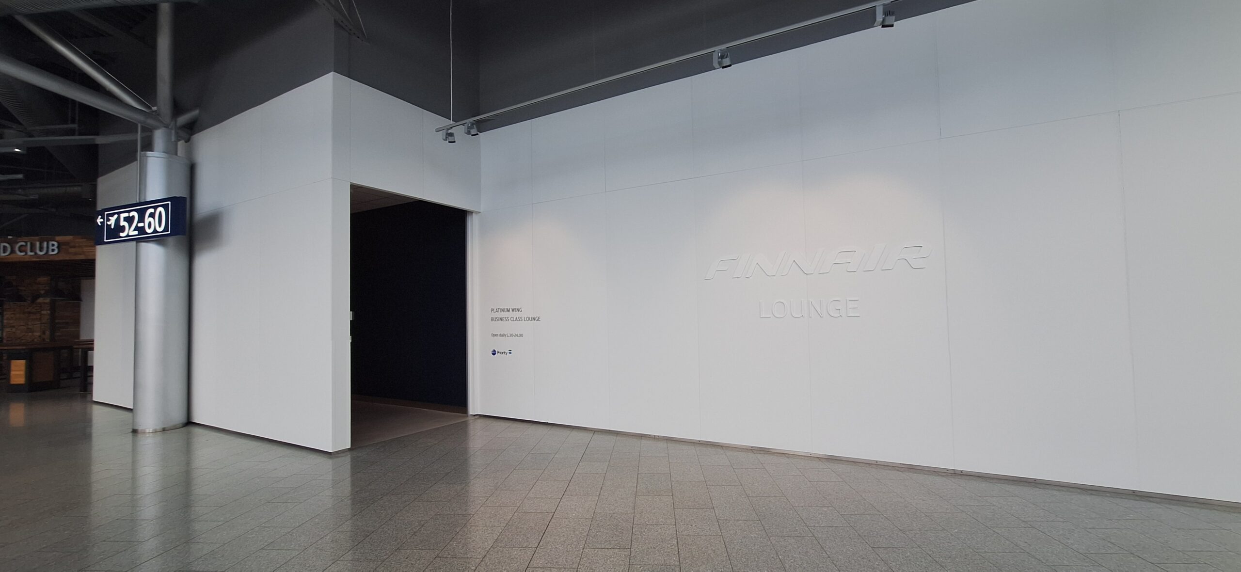 Finnair Business Class Lounge a white wall with a black door