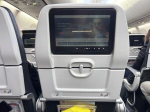 a screen on the seat of an airplane