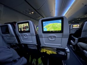 a row of seats with monitors on the back