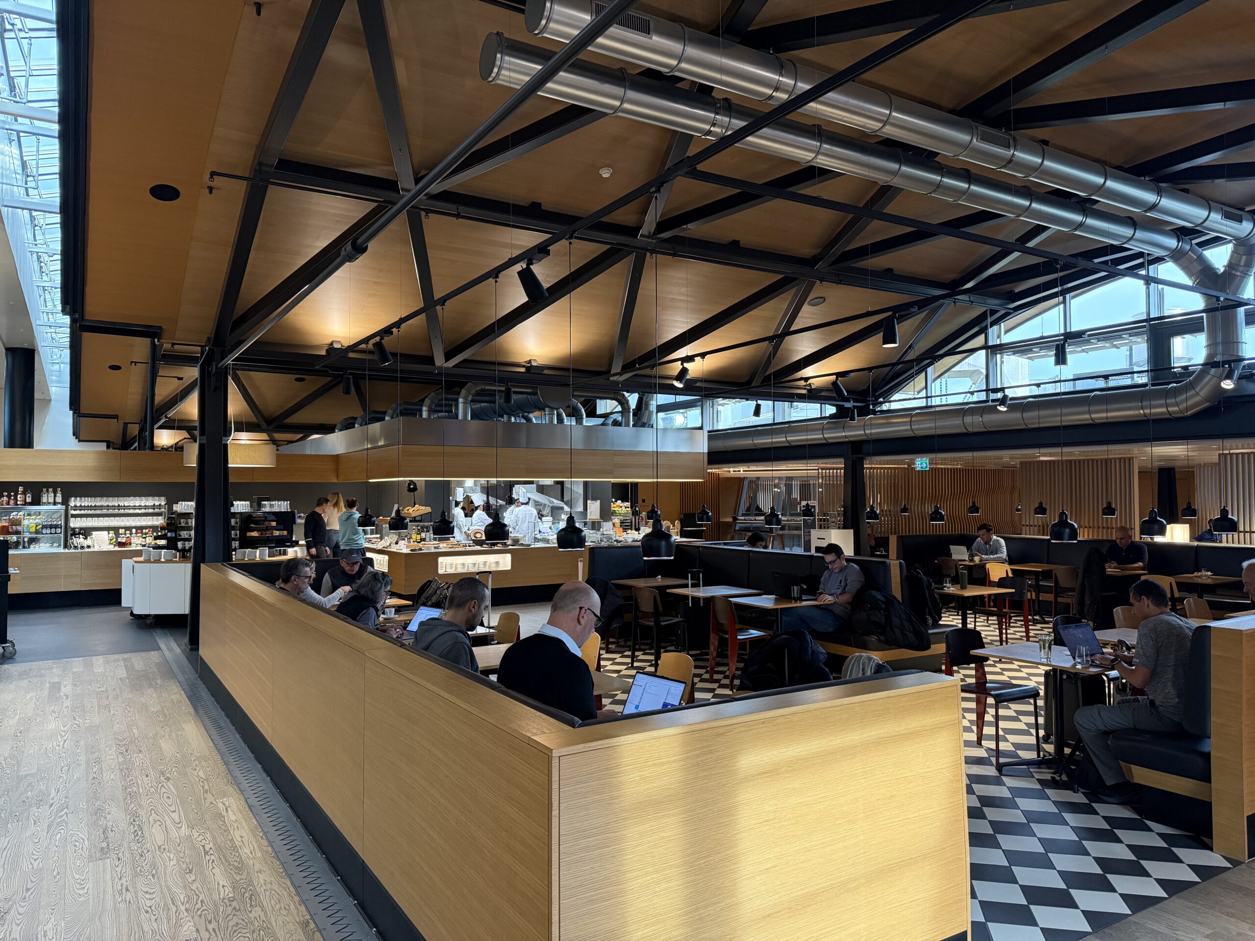 Swiss Senator Lounge Zurich Terminal A Review a group of people sitting at tables in a restaurant