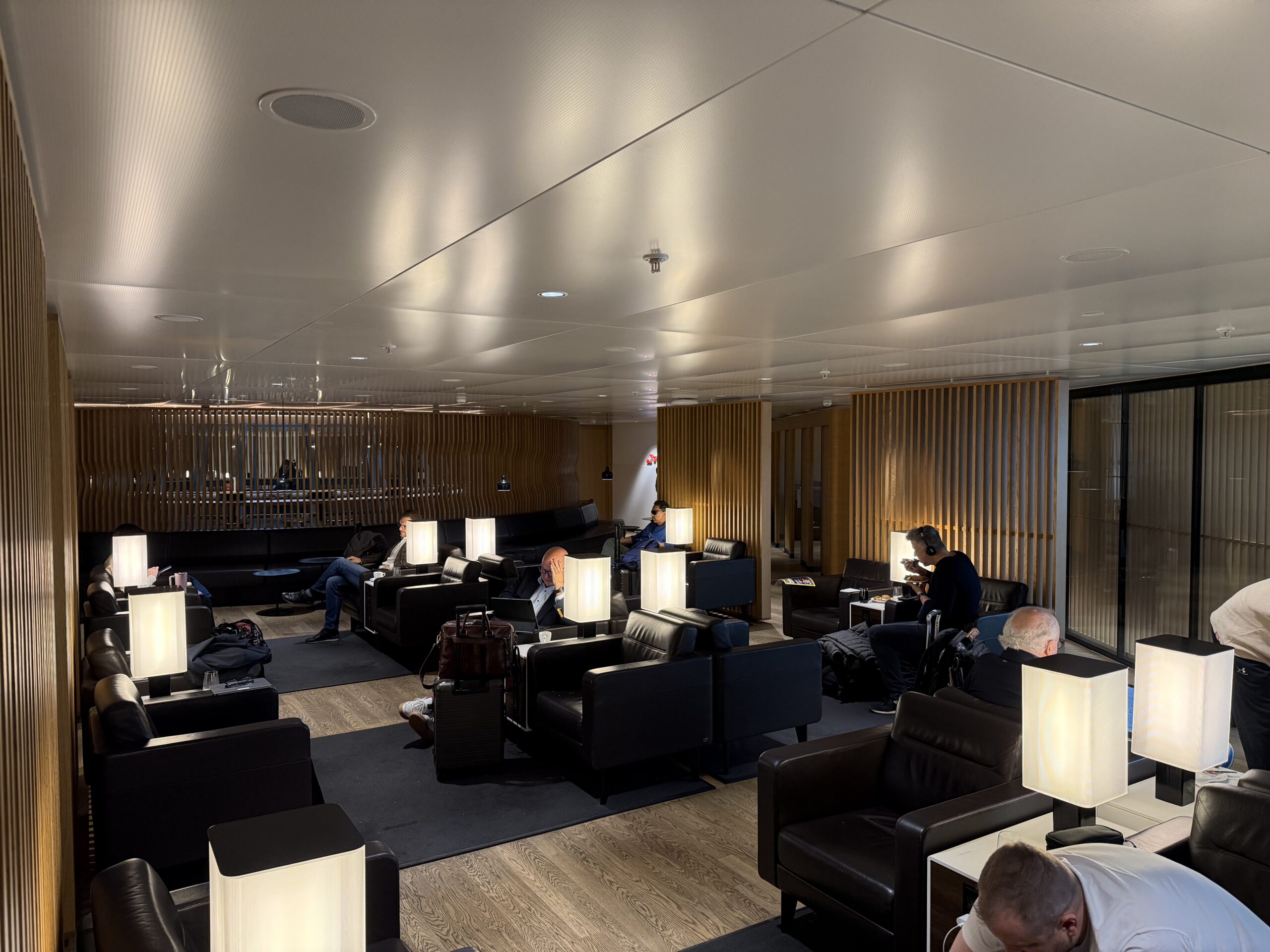 Swiss Senator Lounge Zurich Terminal A Review a group of people sitting in a lounge area