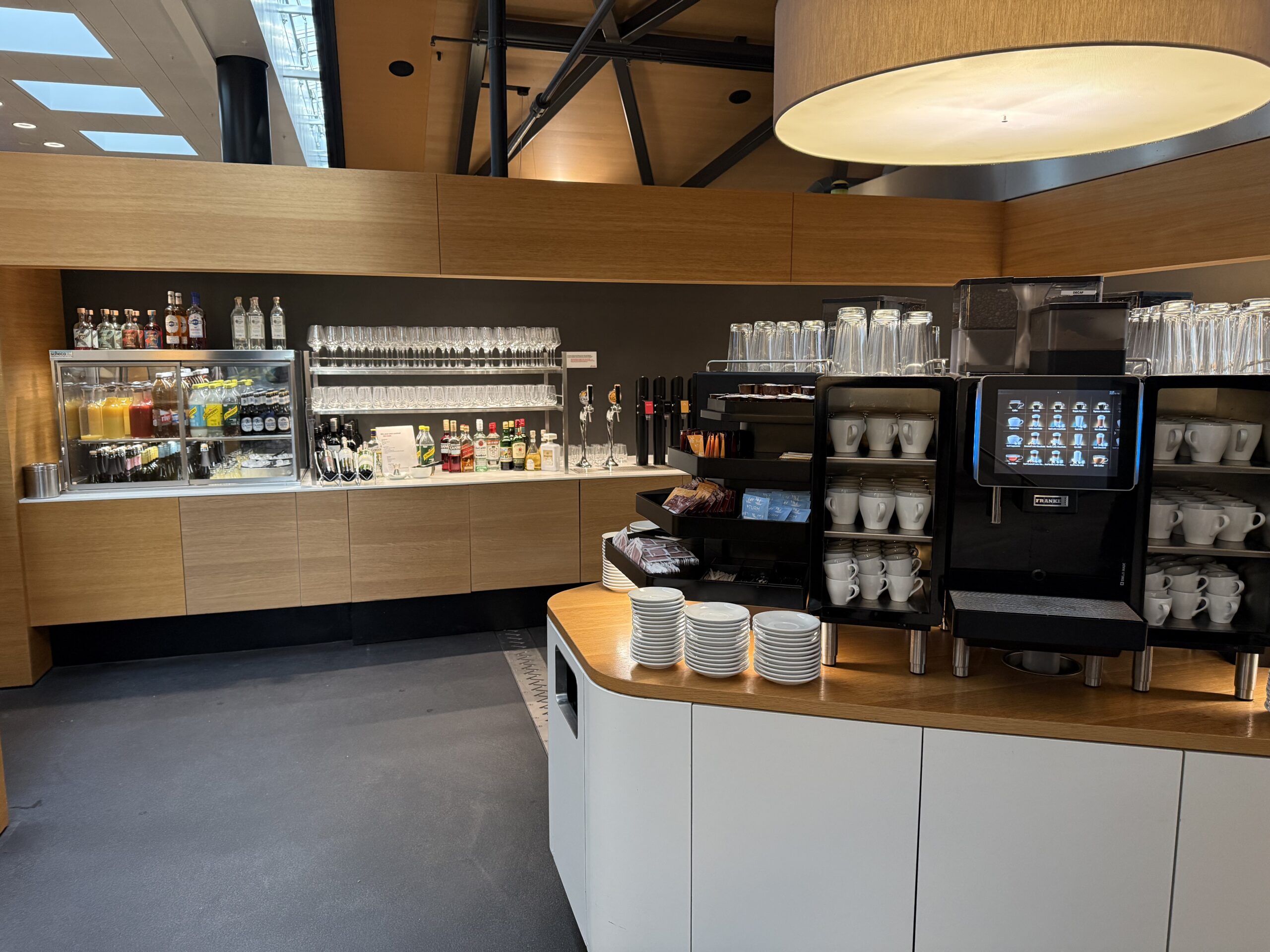 Swiss Senator Lounge Zurich Terminal A Review a coffee bar with a variety of glasses and cups
