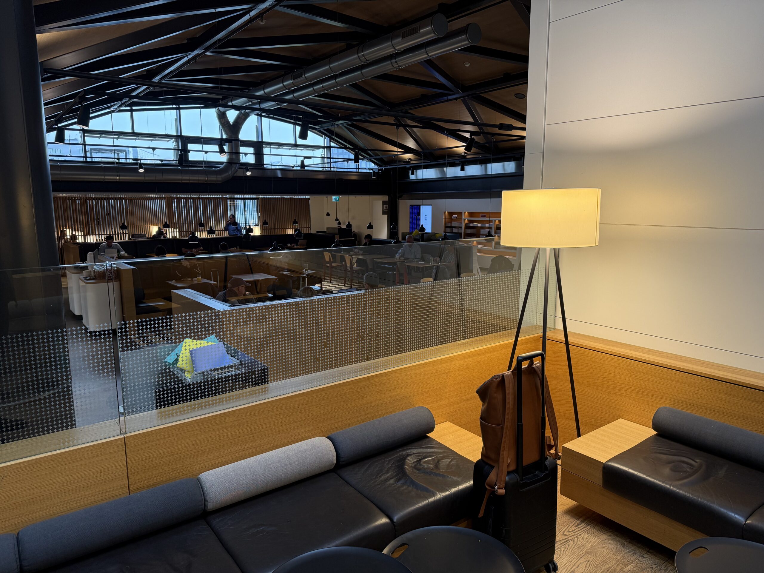 Swiss Senator Lounge Zurich Terminal A Review a room with a lamp and a couch
