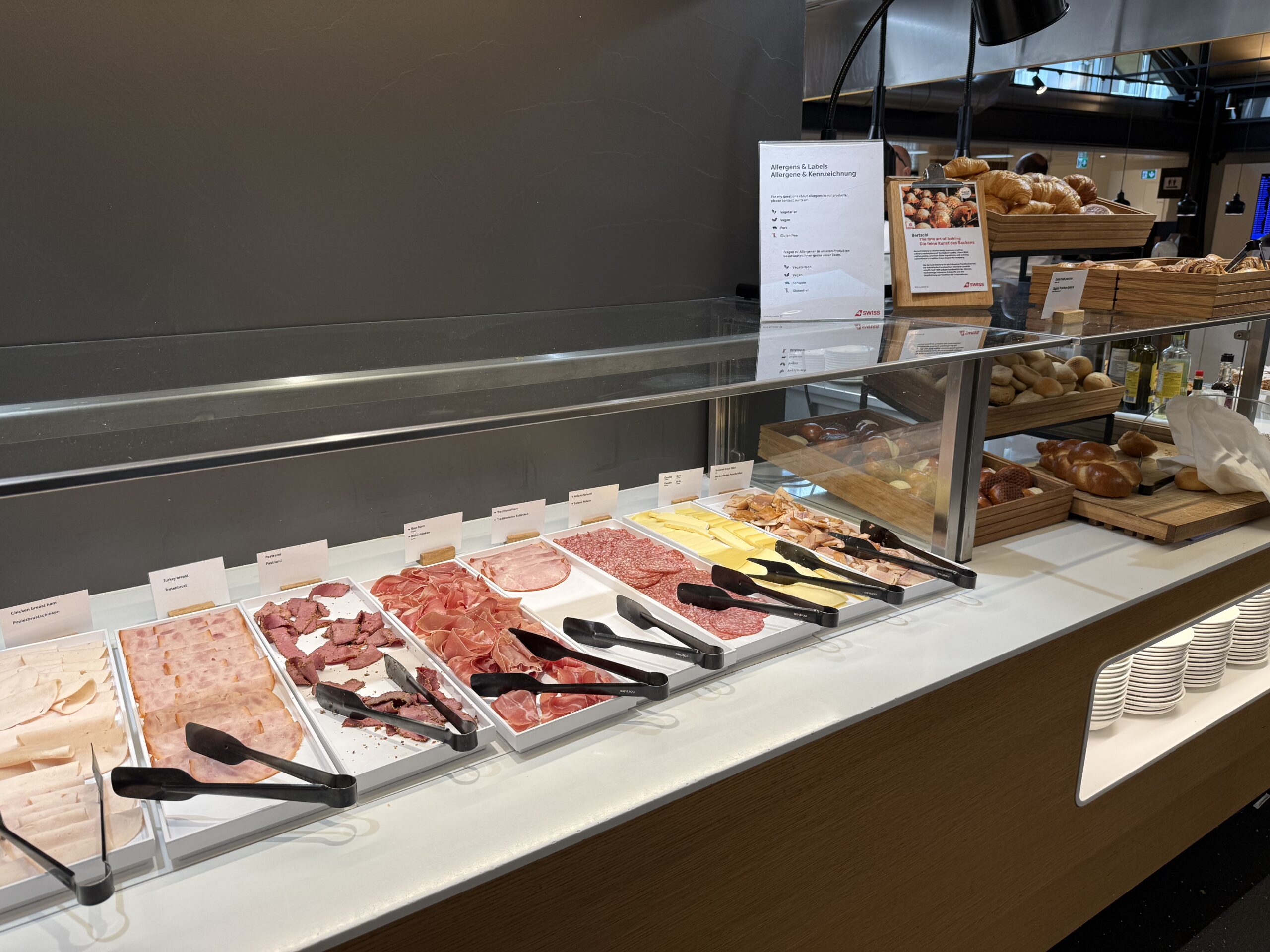 Swiss Senator Lounge Zurich Terminal A Review a display case with different types of meat