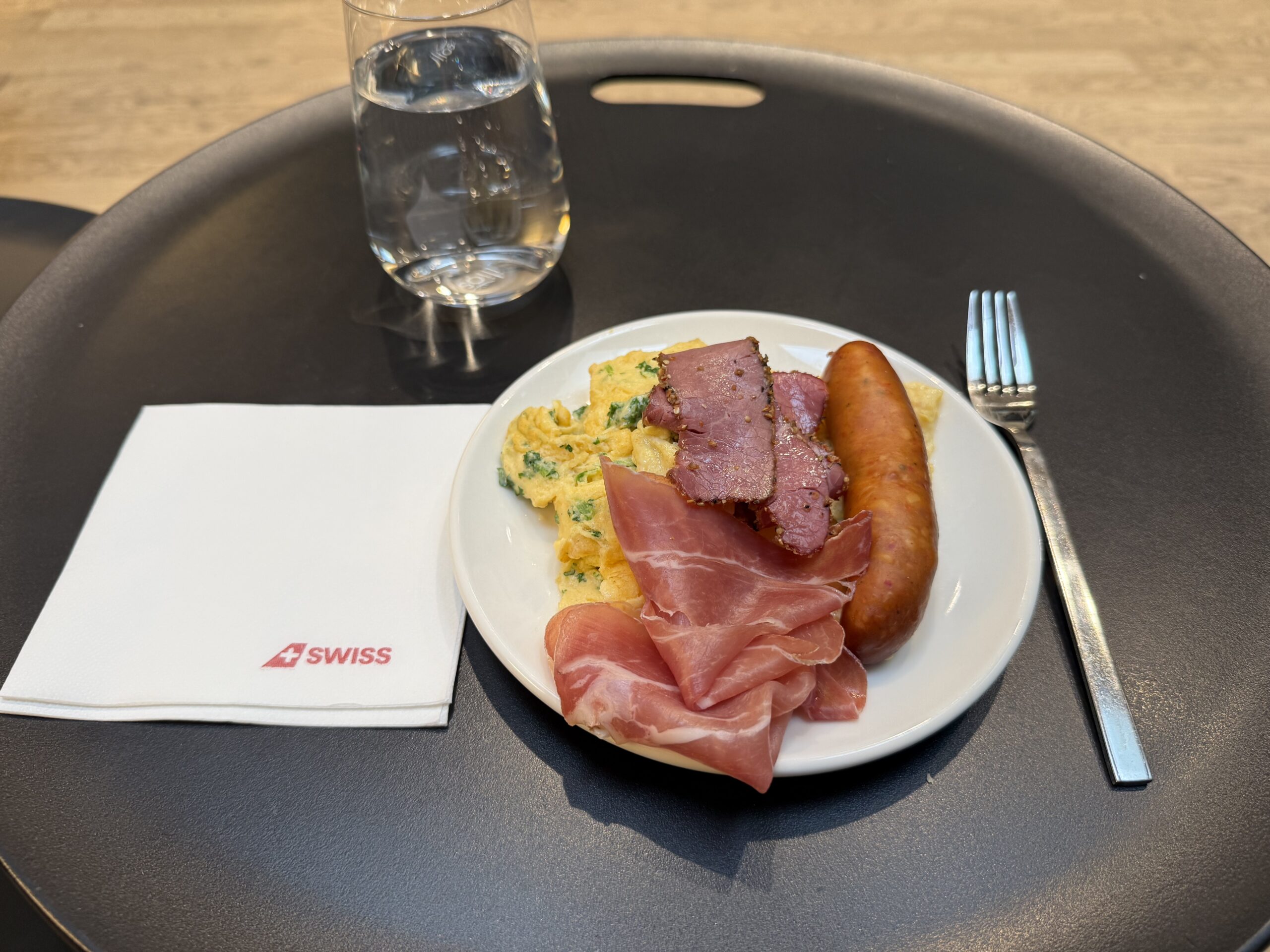 Swiss Senator Lounge Zurich Terminal A Review a plate of food and a fork on a table