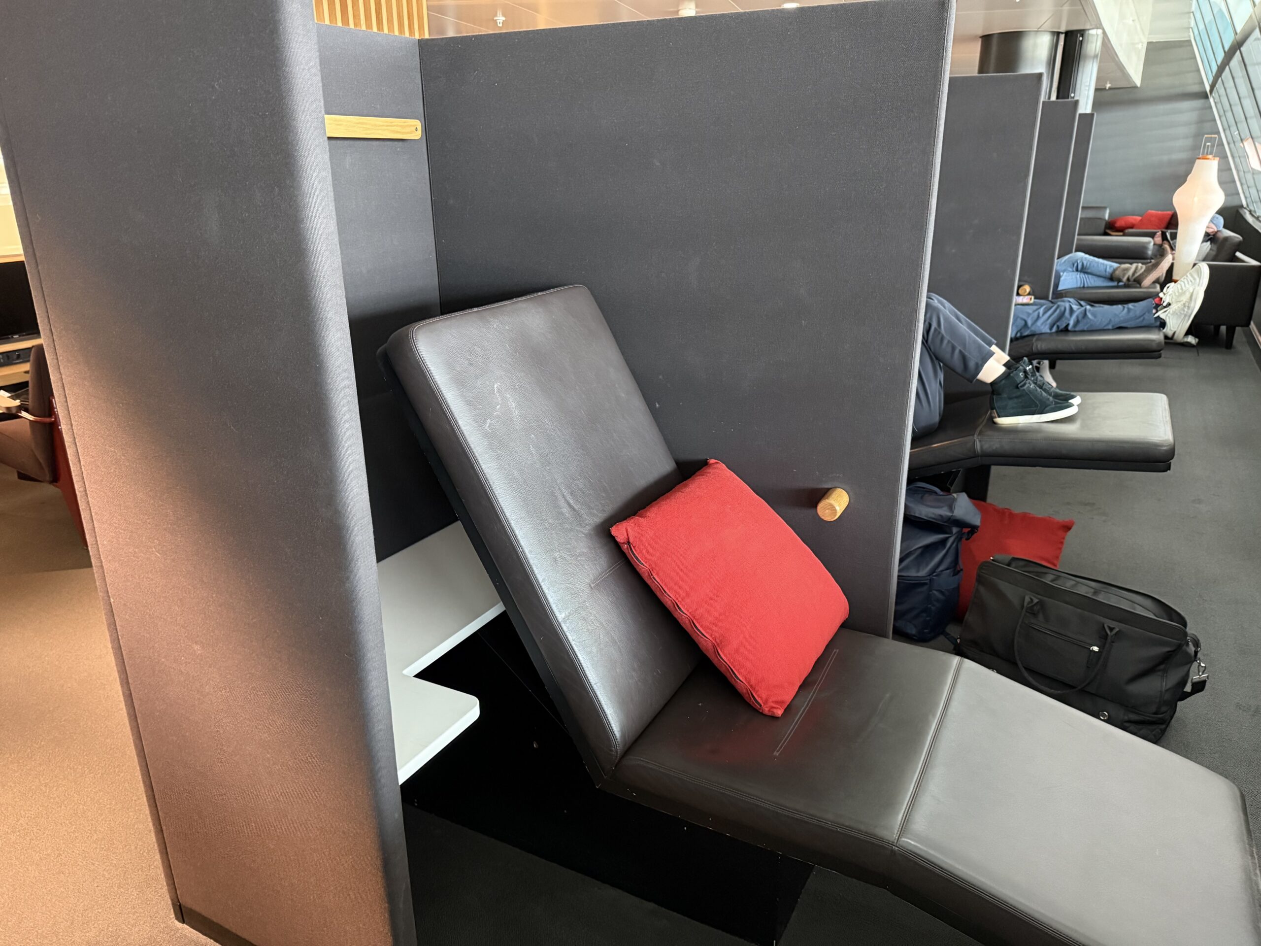Swiss Senator Lounge Zurich Terminal A Review a chair with a red pillow