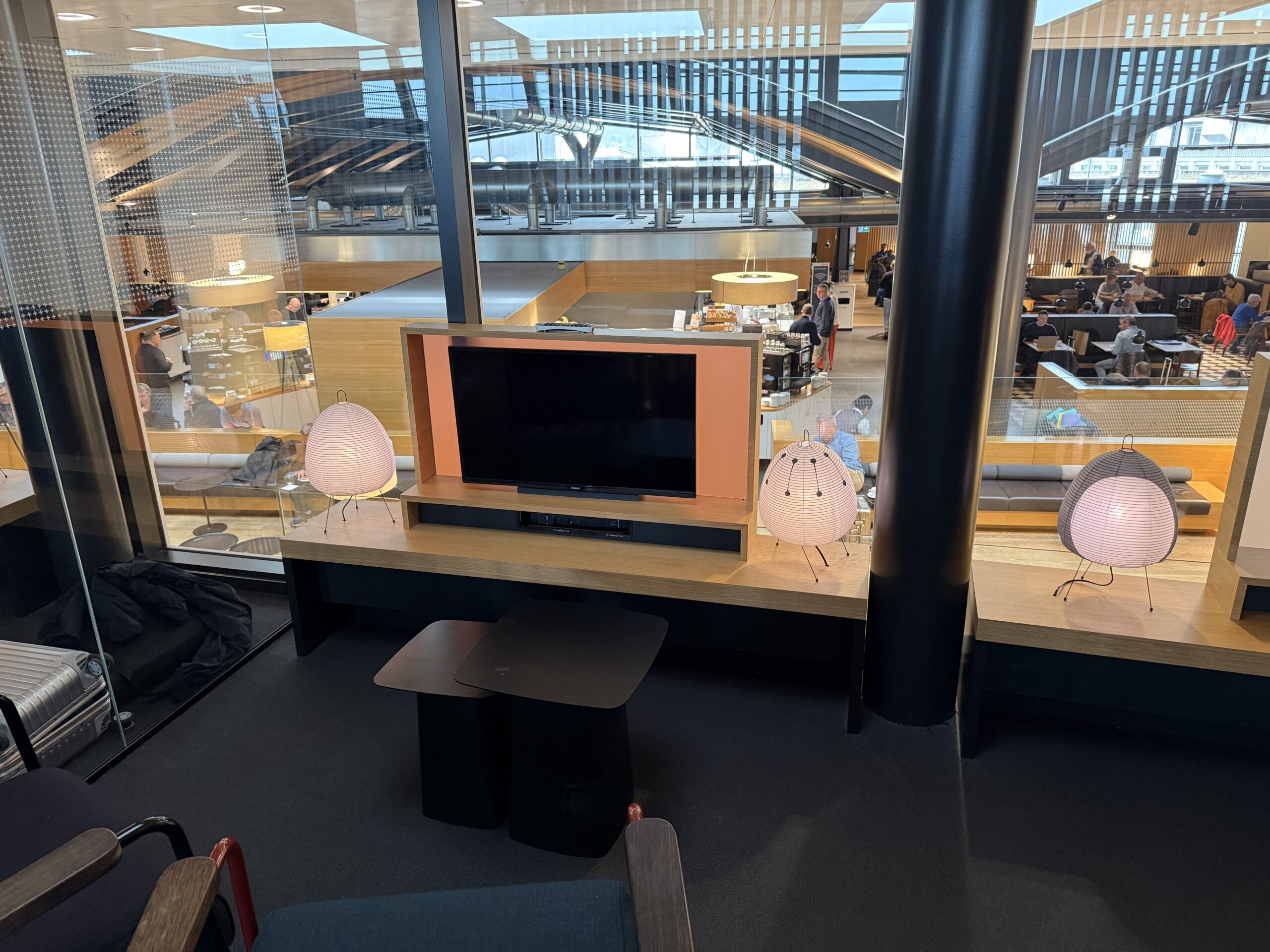 Swiss Senator Lounge Zurich Terminal A Review a room with a television and chairs