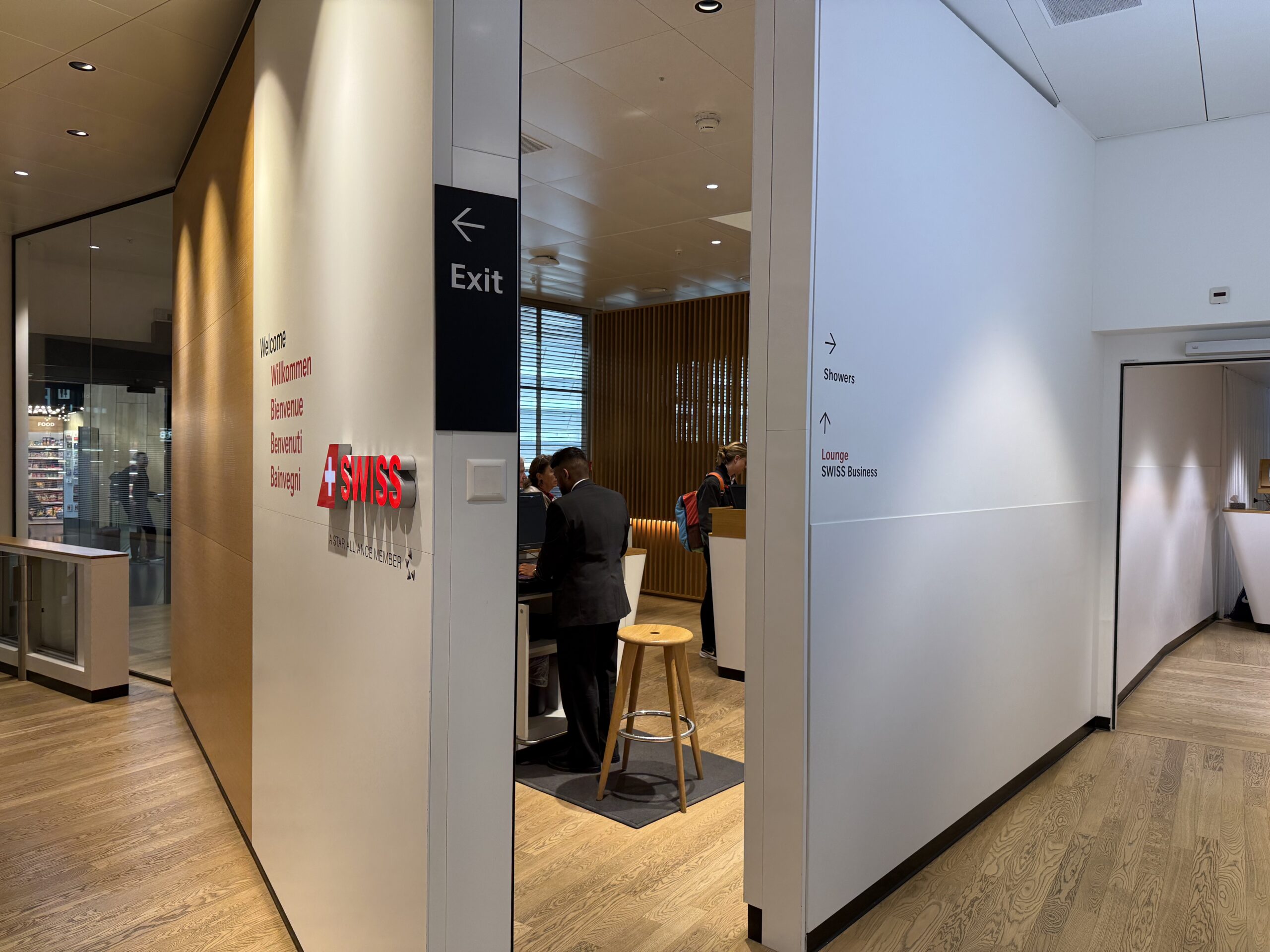 Swiss Senator Lounge Zurich Terminal A Review a group of people standing in a room