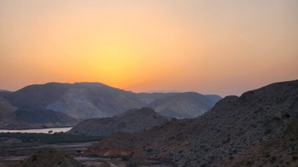 a sunset over a mountain range