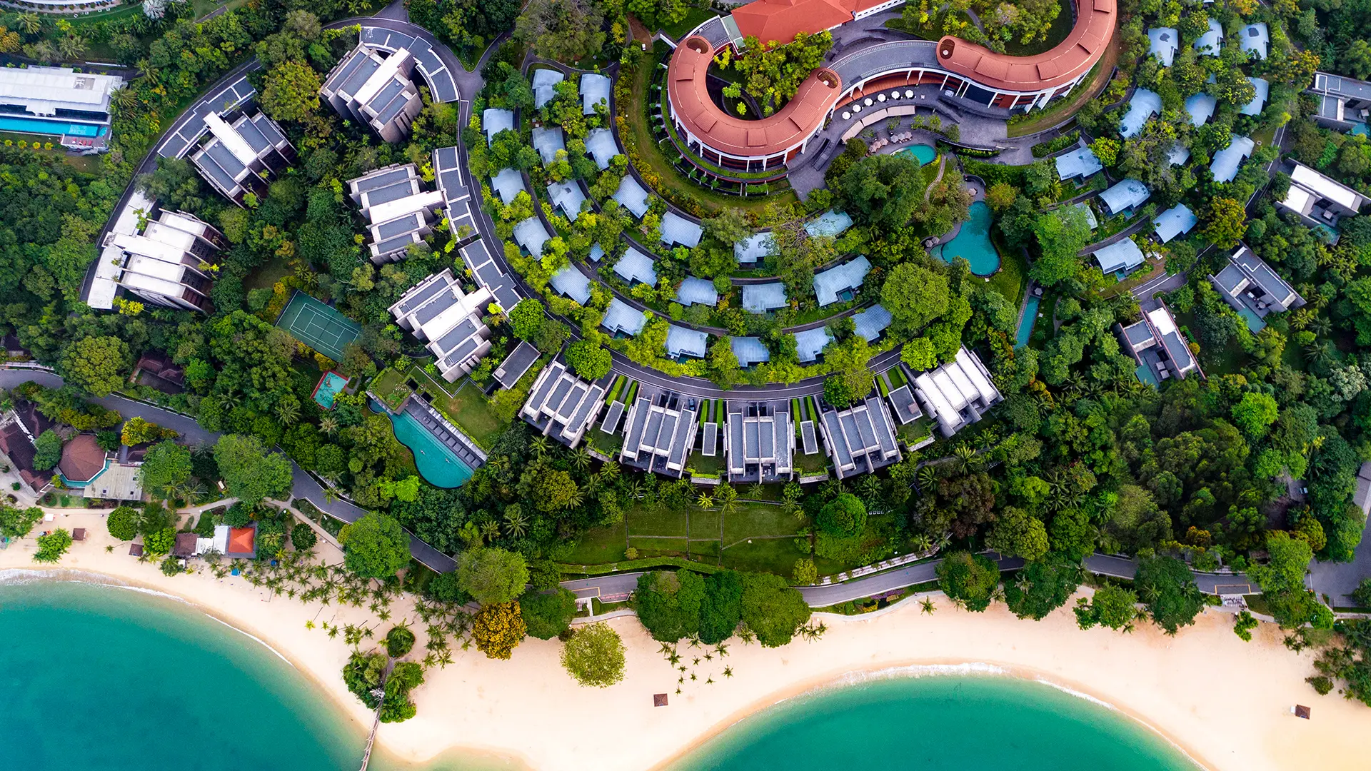 a aerial view of a resort with a beach and trees