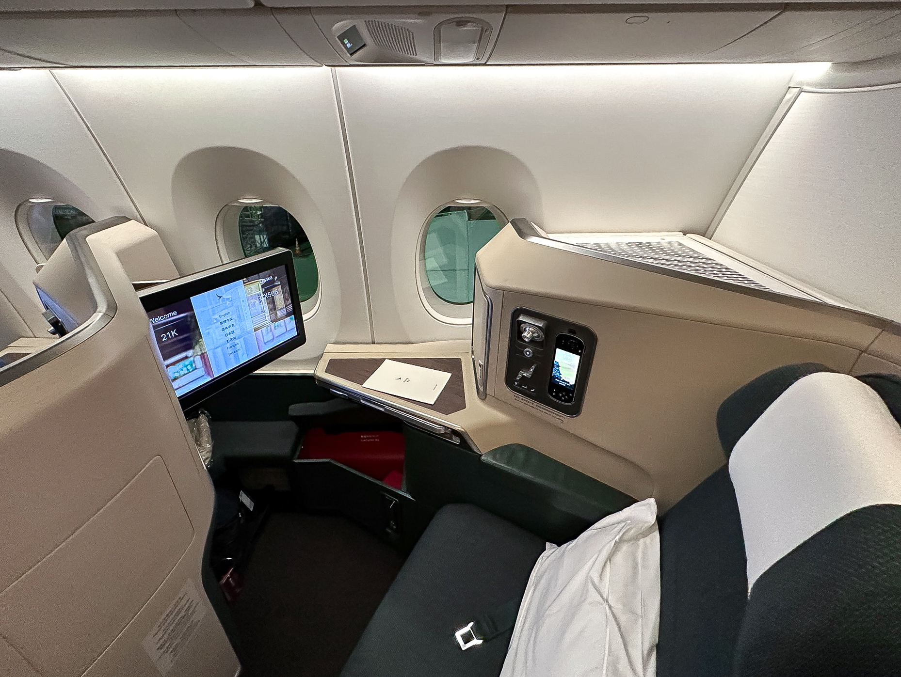 a seat with a monitor and a window in the back