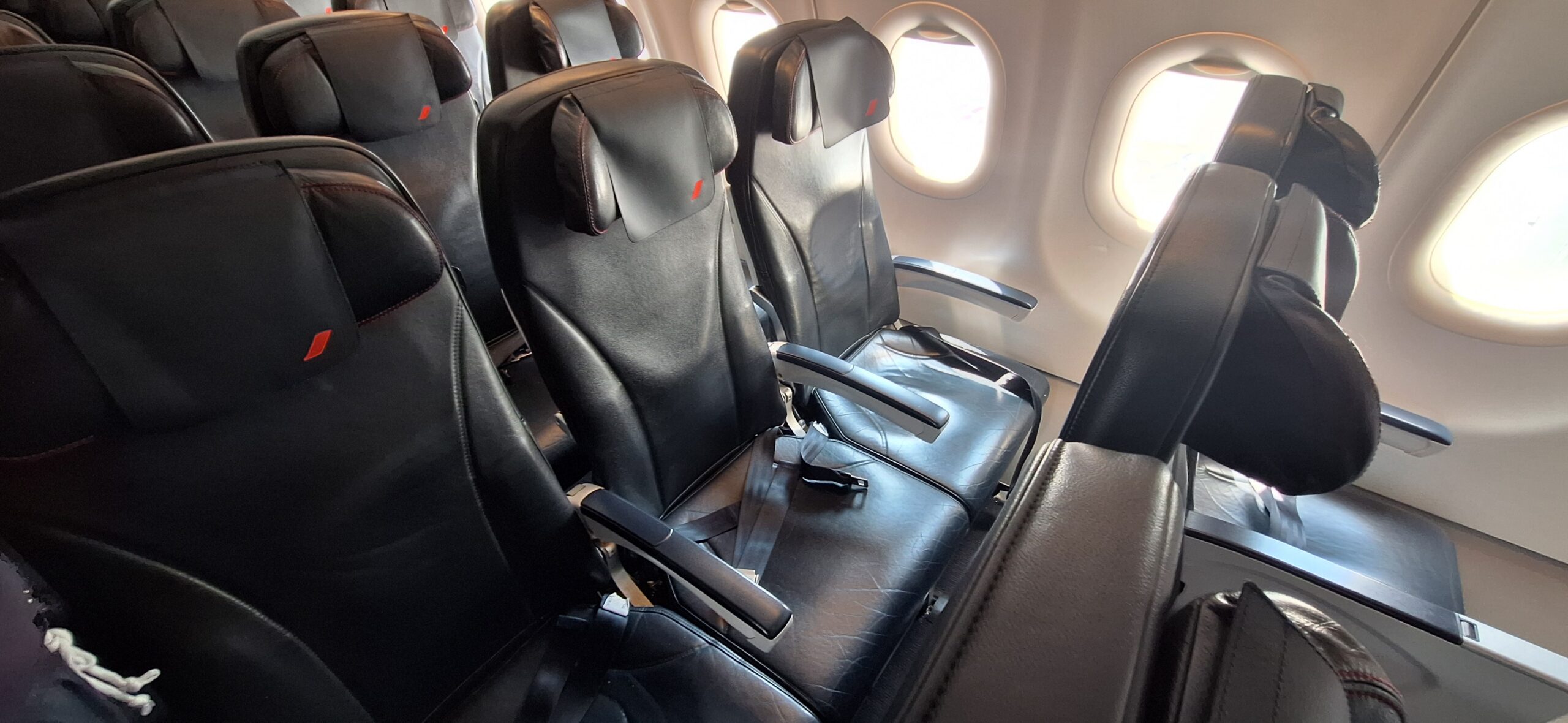 a row of black seats in an airplane