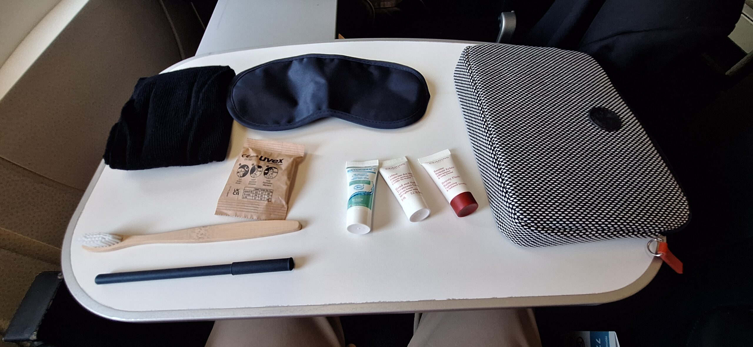 a table with a bag and a mask and other items