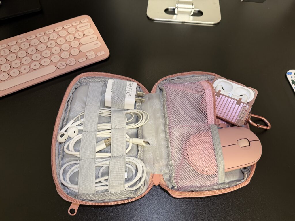PMB Team's Must-Have Travel Products a pink case with a mouse and earphones in it