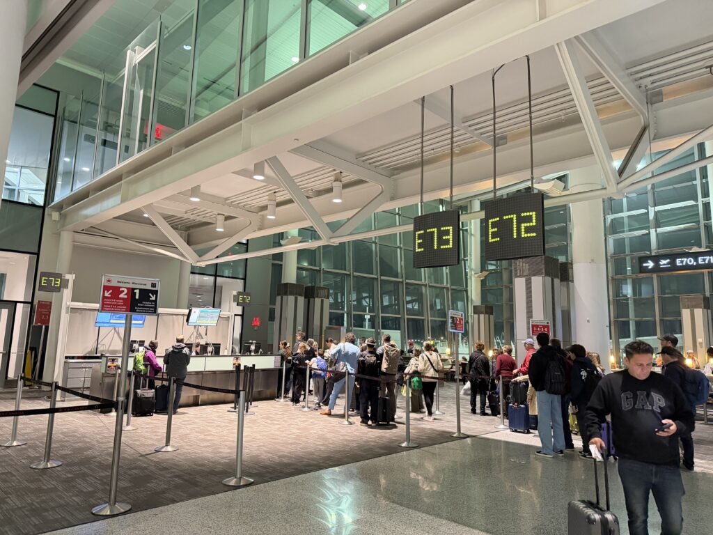 a group of people standing in a line in an airport