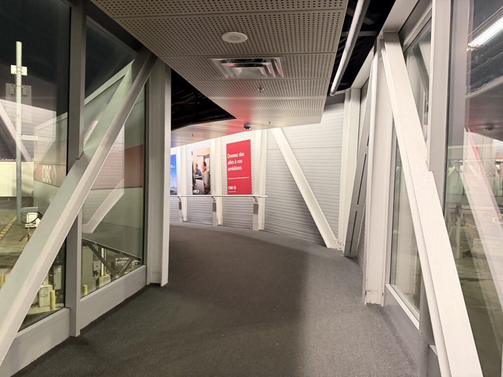 a hallway with glass doors and a sign