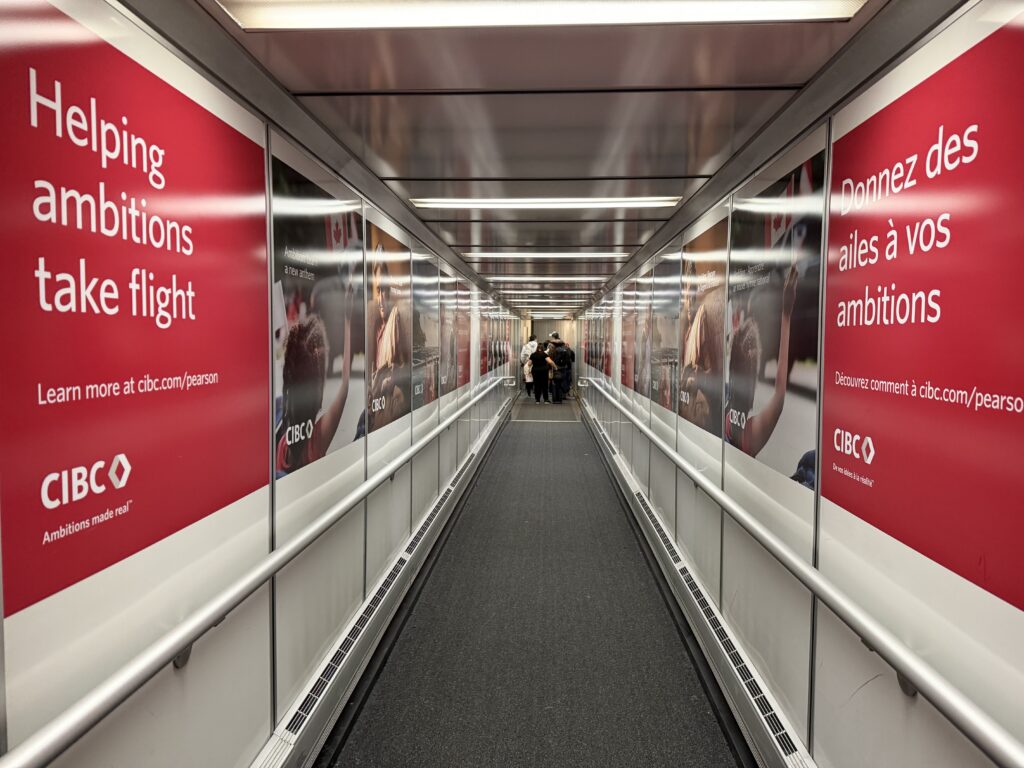 a long hallway with a walkway and people walking