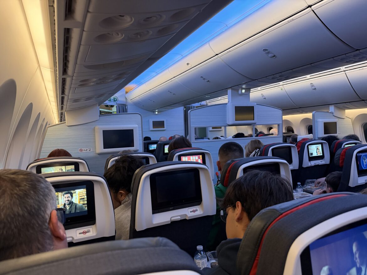 a group of people sitting in an airplane