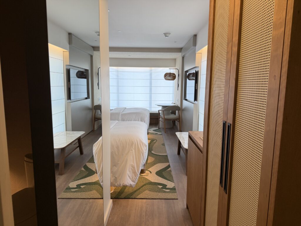 a room with two beds and a table